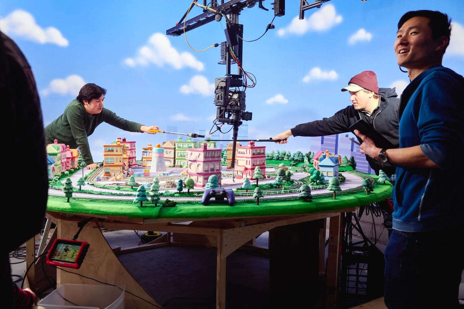 The crew and a camera crane around a colourful miniature television set