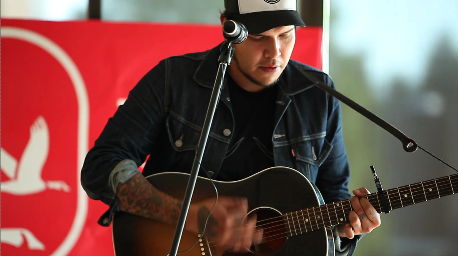 A musician playing an acoustic guitar